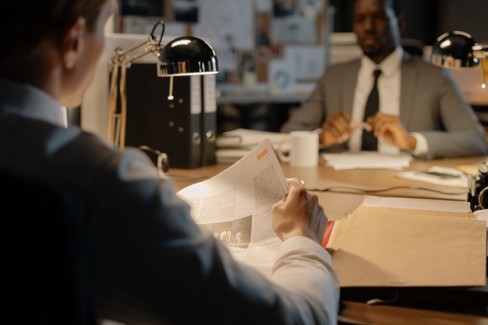 Businessmen reviewing legal documents in an office.