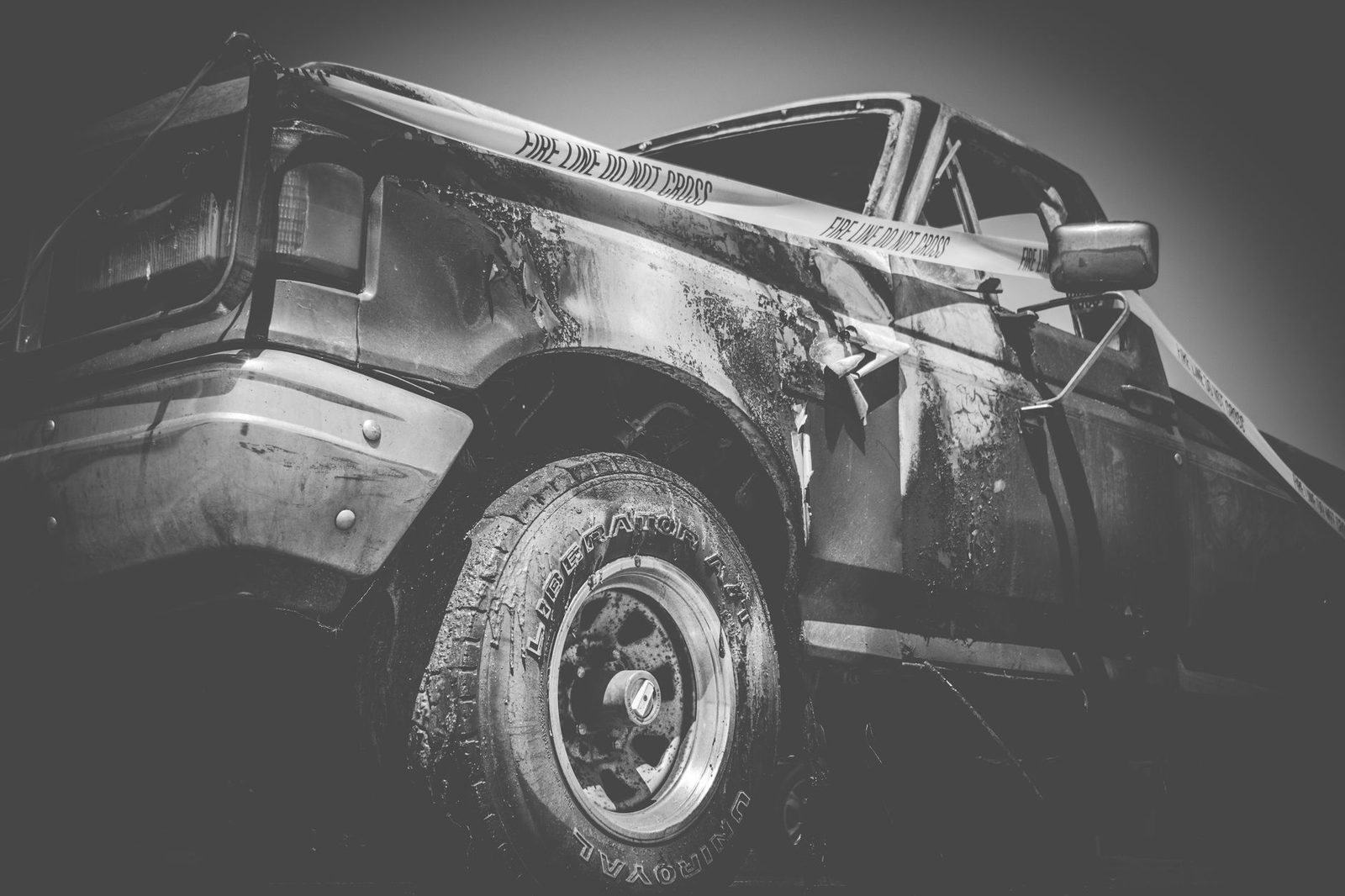 Damaged truck with police tape at accident scene.