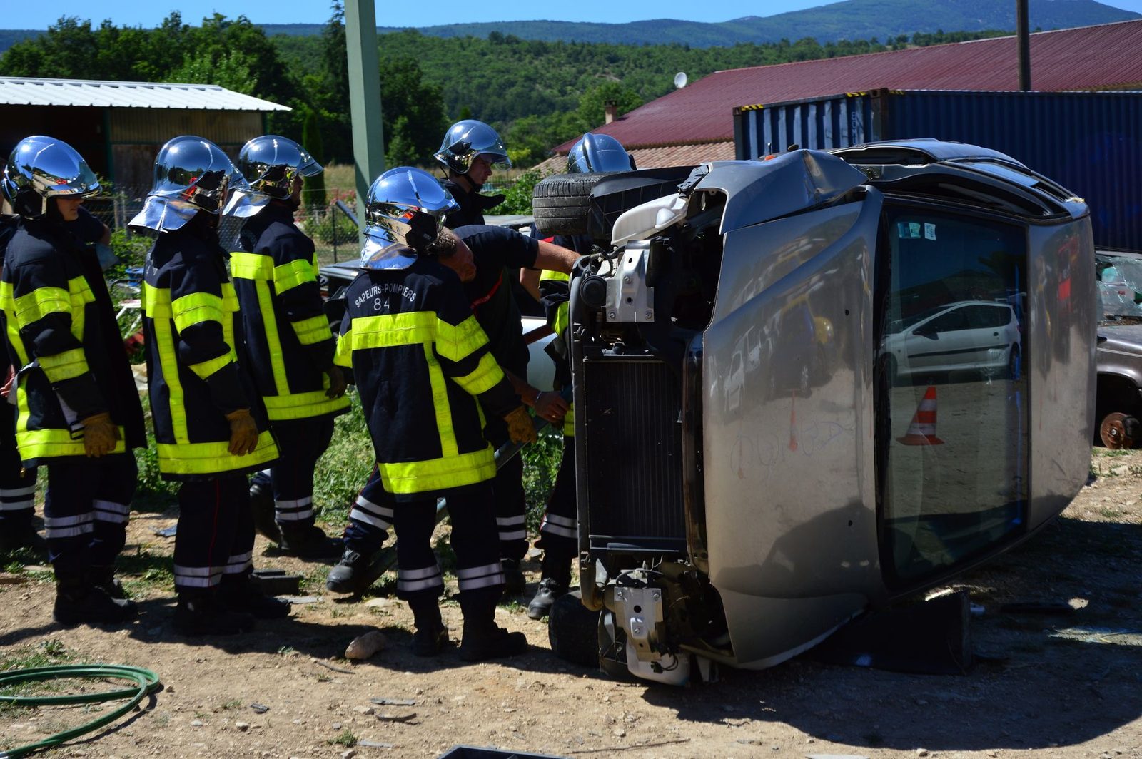 Firefighters responding to overturned vehicle accident scene.