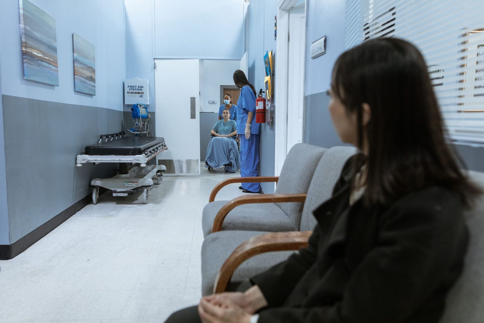 Medical staff and patients in a hospital corridor.