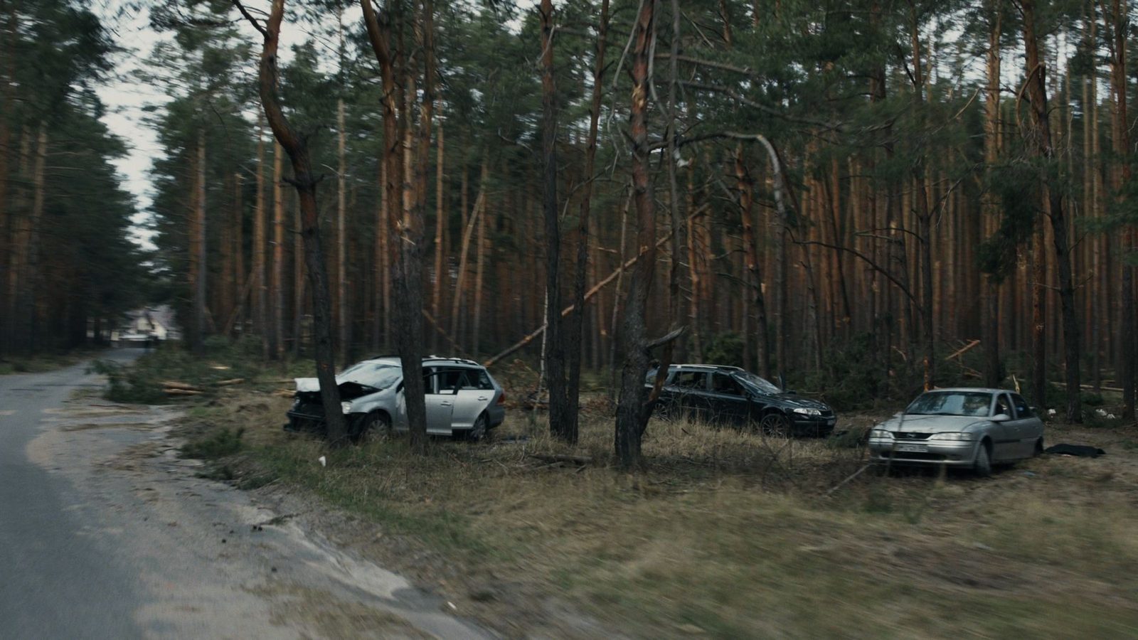 Damaged vehicles in a wooded area in Kyiv after a road accident