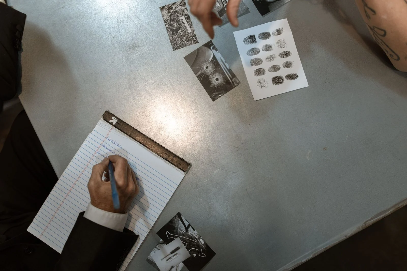Police officers reviewing evidence and case notes during an investigation.