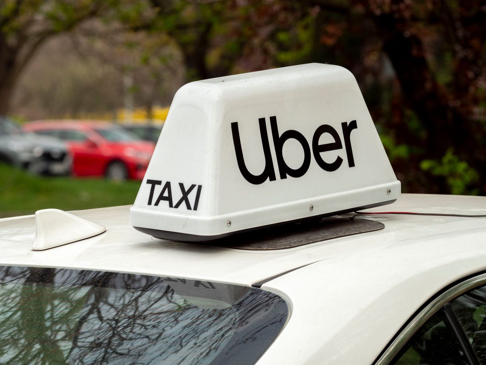 White Uber taxi roof sign on a car in Wrocław, Poland.
