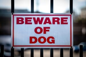 A ‘beware of dog’ sign on a fence. A Duluth dog bite lawyer can help you after an animal attack.